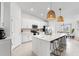 Bright kitchen featuring white cabinets, a large island with seating, and modern appliances at 12440 Wellen Golf St # 204, Venice, FL 34293