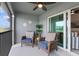 Comfortable lanai features two wicker chairs with cushions, ceiling fan and sliding glass doors at 12440 Wellen Golf St # 204, Venice, FL 34293