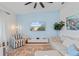Cozy living room with comfortable seating, accent wall, and view of the outdoor scenery through a sliding glass door at 12440 Wellen Golf St # 204, Venice, FL 34293