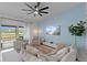Inviting living room featuring a comfortable sectional, striped armchairs, and access to a private balcony at 12440 Wellen Golf St # 204, Venice, FL 34293