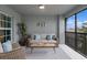 Serene covered patio with comfortable seating, modern decor, and a view of the outdoors at 12440 Wellen Golf St # 204, Venice, FL 34293