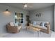 Relaxing covered patio features cozy seating, stylish decor, and a ceiling fan for ultimate comfort at 12440 Wellen Golf St # 204, Venice, FL 34293