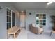 Charming covered patio featuring comfortable chair seating, bench, and stylish decor at 12440 Wellen Golf St # 204, Venice, FL 34293