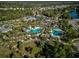 Overhead community pool and clubhouse are surrounded by lush landscaping and neighborhood at 12689 Sagewood Dr, Venice, FL 34293
