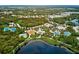 Beautiful aerial view of community amenities featuring pool, playground, and tennis courts at 12689 Sagewood Dr, Venice, FL 34293