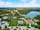 Aerial view of community amenities, including a splash pad, playground, pool, and lake at 12689 Sagewood Dr, Venice, FL 34293