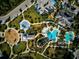 Bird's-eye view of community pool, playground, and amenities with parking lot at 12689 Sagewood Dr, Venice, FL 34293