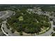 Aerial view of a central park in a residential neighborhood with winding walking paths and lush greenery at 12689 Sagewood Dr, Venice, FL 34293