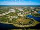 Aerial view of a beautiful community featuring lakes, walking paths, and tennis courts at 12689 Sagewood Dr, Venice, FL 34293