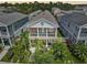 Aerial view of a two-story home featuring a charming balcony and a well-manicured lawn at 12689 Sagewood Dr, Venice, FL 34293