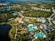 Community featuring lake, pool, playground, and clubhouse surrounded by homes from above at 12689 Sagewood Dr, Venice, FL 34293