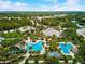 Aerial view showcases a community with resort-style pool, clubhouse, playground, and manicured landscaping at 12689 Sagewood Dr, Venice, FL 34293
