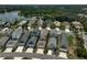 Aerial view showcases a community with homes with private driveways and manicured lawns and landscaping at 12689 Sagewood Dr, Venice, FL 34293