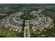 Primary-planned community aerial view featuring lakes, central park, walking trails, and meticulously landscaped properties at 12689 Sagewood Dr, Venice, FL 34293