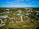 Aerial showcases community pool and clubhouse with lush landscaping and trees at 12689 Sagewood Dr, Venice, FL 34293
