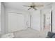A bedroom featuring carpet floors, a ceiling fan, and closet space at 12689 Sagewood Dr, Venice, FL 34293