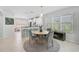 Dining area with a round table and seating, with views into the kitchen and living room at 12689 Sagewood Dr, Venice, FL 34293
