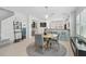 Bright dining area with views of the kitchen, stairs, and open-concept layout for easy entertaining at 12689 Sagewood Dr, Venice, FL 34293