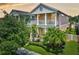Charming two-story home with lush landscaping, inviting front porch and a second-story balcony at 12689 Sagewood Dr, Venice, FL 34293
