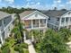Two-story home boasting a charming balcony, a well-manicured lawn, and lush tropical landscaping at 12689 Sagewood Dr, Venice, FL 34293