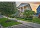 Inviting two-story home featuring a covered porch, a second-story balcony, and lush landscaping at 12689 Sagewood Dr, Venice, FL 34293