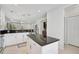 Bright kitchen with white cabinets, dark countertops, and an open design for modern living at 12689 Sagewood Dr, Venice, FL 34293