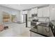 This kitchen has white cabinets, stainless appliances, and granite countertops at 12689 Sagewood Dr, Venice, FL 34293