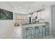 Modern kitchen with white cabinets, stainless steel appliances, granite countertops and breakfast bar at 12689 Sagewood Dr, Venice, FL 34293