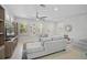 Inviting living room with tile flooring, plantation shutters, ceiling fan and open layout at 12689 Sagewood Dr, Venice, FL 34293