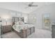 Light filled main bedroom with ceiling fan and neutral carpet at 12689 Sagewood Dr, Venice, FL 34293