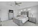 Light filled main bedroom with ceiling fan and neutral carpet at 12689 Sagewood Dr, Venice, FL 34293