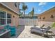 Private outdoor patio offering privacy fencing and pavers, furnished with lounge chairs at 12689 Sagewood Dr, Venice, FL 34293