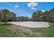 Sand volleyball court with mature landscaping at 12689 Sagewood Dr, Venice, FL 34293