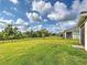 Large backyard featuring lush grass, and black metal fence, surrounding the perimeter at 12705 Pinnacle Ln, Venice, FL 34293