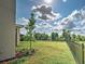 Spacious backyard featuring healthy green grass, black metal fence, and well placed landscaping at 12705 Pinnacle Ln, Venice, FL 34293