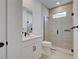Modern bathroom featuring a glass shower, tiled walls, and a sleek vanity with a white countertop at 12705 Pinnacle Ln, Venice, FL 34293