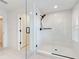 A modern bathroom features a glass walk-in shower and black hardware at 12705 Pinnacle Ln, Venice, FL 34293