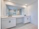 Bright bathroom features double sinks, a makeup vanity, and a walk-in shower at 12705 Pinnacle Ln, Venice, FL 34293