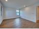 A bright bedroom boasting hardwood floors, a modern window, and fresh, white walls at 12705 Pinnacle Ln, Venice, FL 34293