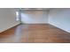 A bedroom features sleek wood flooring and neutral paint at 12705 Pinnacle Ln, Venice, FL 34293