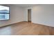 Bright bedroom featuring hardwood floors, a modern window, and a closet with an open door at 12705 Pinnacle Ln, Venice, FL 34293