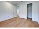 Bright bedroom with hardwood floors, a closet with sliding doors, and minimalist decor at 12705 Pinnacle Ln, Venice, FL 34293