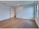 Spacious bedroom featuring hardwood floors, white walls, and a window with natural light, plus closet at 12705 Pinnacle Ln, Venice, FL 34293