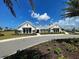 Stunning exterior view of the community clubhouse with well-manicured landscaping and a welcoming entrance at 12705 Pinnacle Ln, Venice, FL 34293
