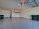 Clean two-car garage with epoxy flooring and storage rack at 12705 Pinnacle Ln, Venice, FL 34293