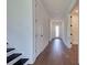 Hallway with hardwood floors, white walls, and a door leading to the exterior at 12705 Pinnacle Ln, Venice, FL 34293