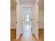 A hallway reveals walk-in closets on either side and a bathroom beyond at 12705 Pinnacle Ln, Venice, FL 34293