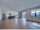 Open-concept kitchen and living area featuring hardwood floors and sliding glass doors to the outside space at 12705 Pinnacle Ln, Venice, FL 34293