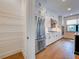 Gourmet kitchen features stainless steel appliances, custom white cabinetry, and a walk-in pantry at 12705 Pinnacle Ln, Venice, FL 34293
