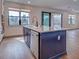 Kitchen island featuring a built-in dishwasher, sink with modern faucet, and plenty of counter space at 12705 Pinnacle Ln, Venice, FL 34293